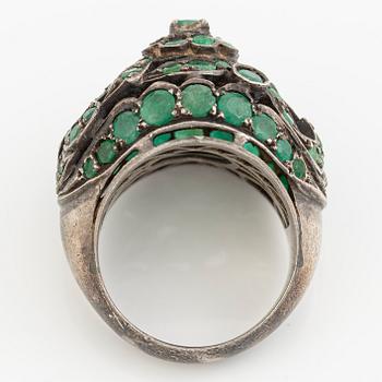 Silver ring with green stones.