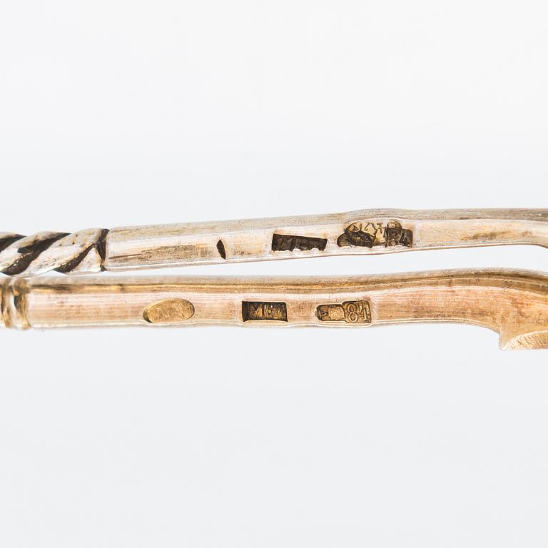 Twelve parcel-gilt teaspoons and a jam spoon, Russia 1887-1926.