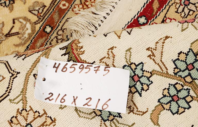 An oriental silk rug, diameter c. 216 cm.