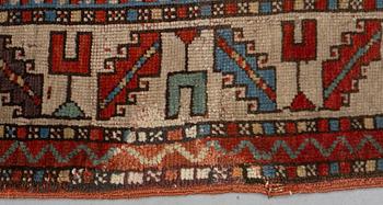 A rug, antique Anatolian/Caucasian, ca 148-149 x 104,5-110 cm (as well as 1-1,5 cm flat weave at one end).