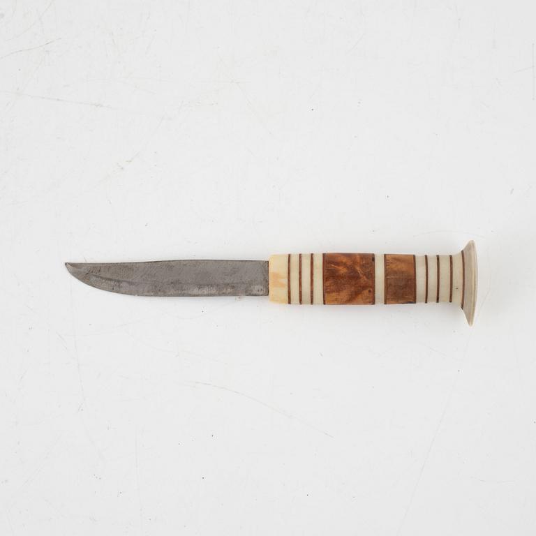 A reindeer horn knife, signed AL.