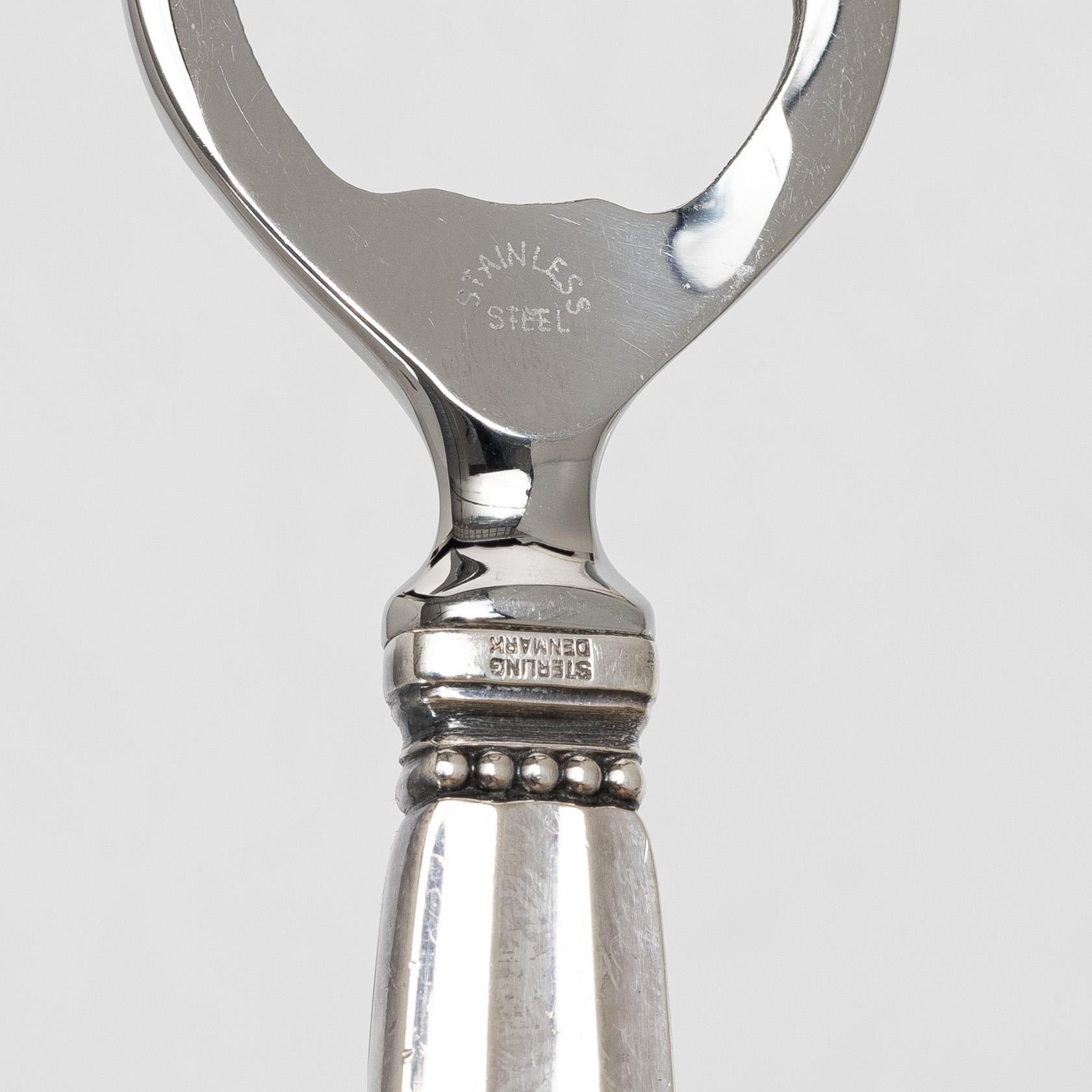 Kapsylöppnare samt sked, silver, "Konge", Georg Jensen.