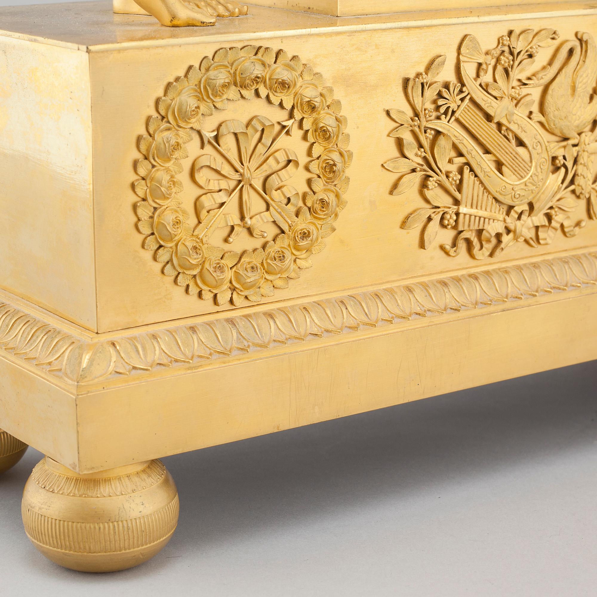 An Empire table clock, dial marked "L Ravrio Bronzier à Paris Mesnil H", fist half of the 20th century.