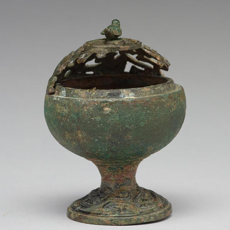 A group of five bronze objects, some Han dynasty (206 BC - 220 AD).