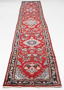 An oriental runner carpet, c. 550 x 75 cm.