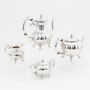 A rococo style sterling silver teapot, coffee pot, creamer and sugar bowl.