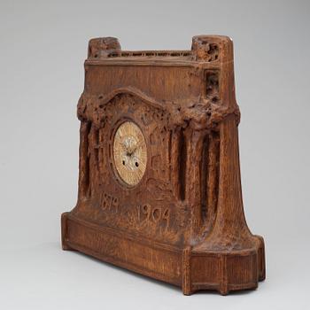 A Swedish Art Nouveau carved pine mantel clock, probably by Rackengruppen.