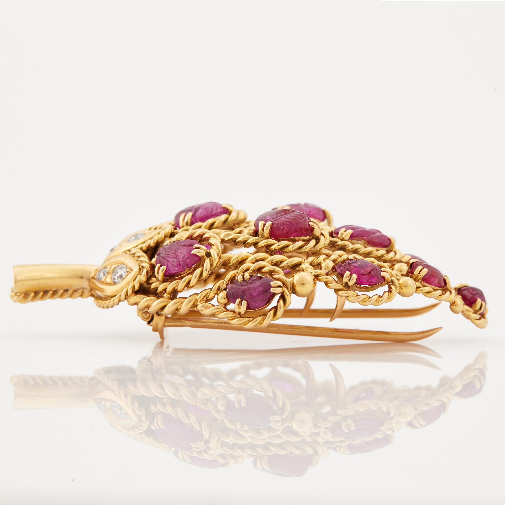 A 1950/60's brooch by Cartier, in the shape of a strawberry, set with carved rubies and brilliant cut diamonds.
