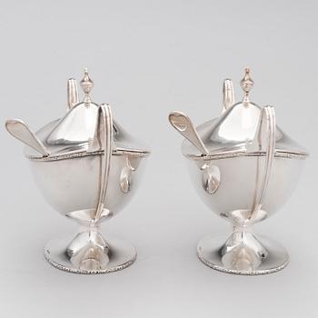 A pair of lidded silver sugar bowls with sprinkle spoons, mark of The Firm Carl Fredrik Carlman, Stockholm 1928-29.