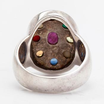 A sterling silver ring with multicoloured precious stones.