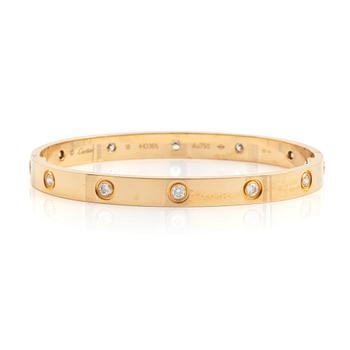 A Cartier "Love" bracelet in 18K gold set with ten round brilliant-cut diamonds.