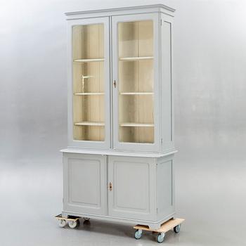 A painted early 1900s display cabinet.