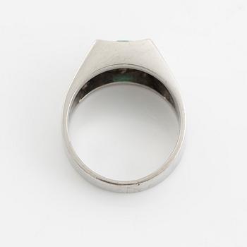 An 18K white gold ring set with a step-cut emerald and round brilliant-cut diamonds.