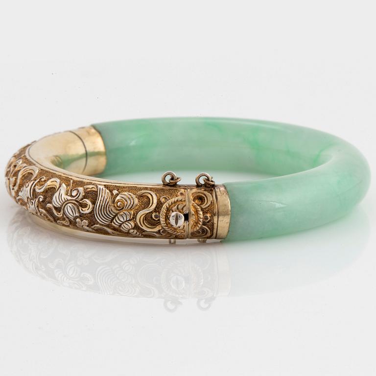 A jadeite and silver bracelet.