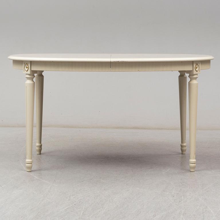 A dining table and 4 chairs, second half of the 20th century. 2 leaves included.