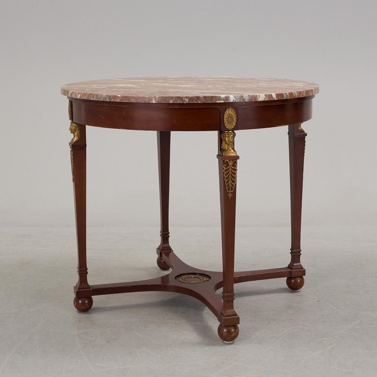 An empire-style table, early 20th century.