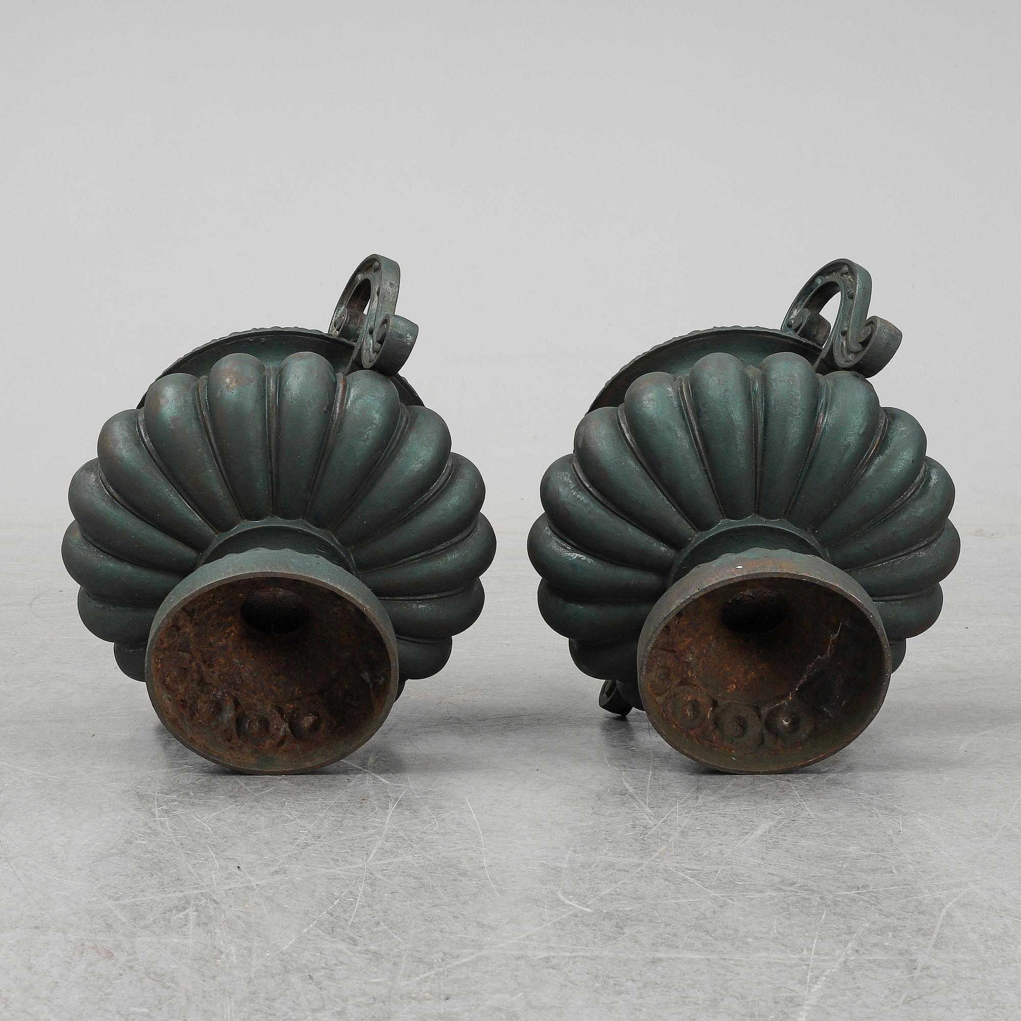 A 20th Century pair of cast iron flower pots.