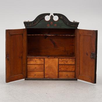 A wall-hanged cabinet, Sweden, dated 1851.