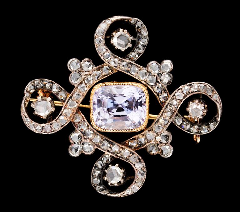 A gold, silver, diamond and pink sapphire brooch.