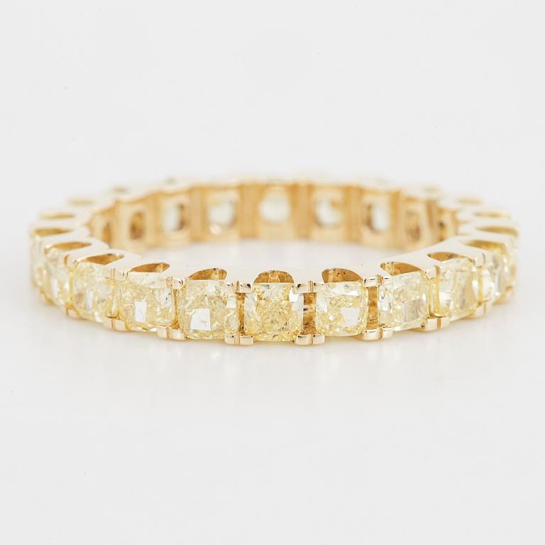 Yellow cushion shaped diamond ring.