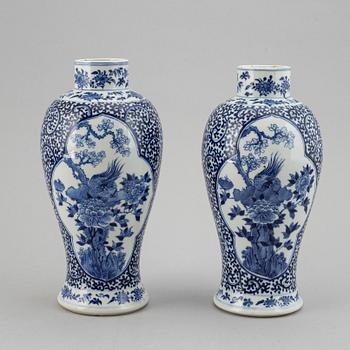 A pair of blue and white vases, Qing dynasty, late 19th century, with a Kangxi mark to the base.