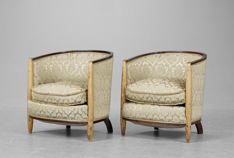 A pair of French partly gilt palisander armchairs in the manner of Poul Follot, 1920-30's.