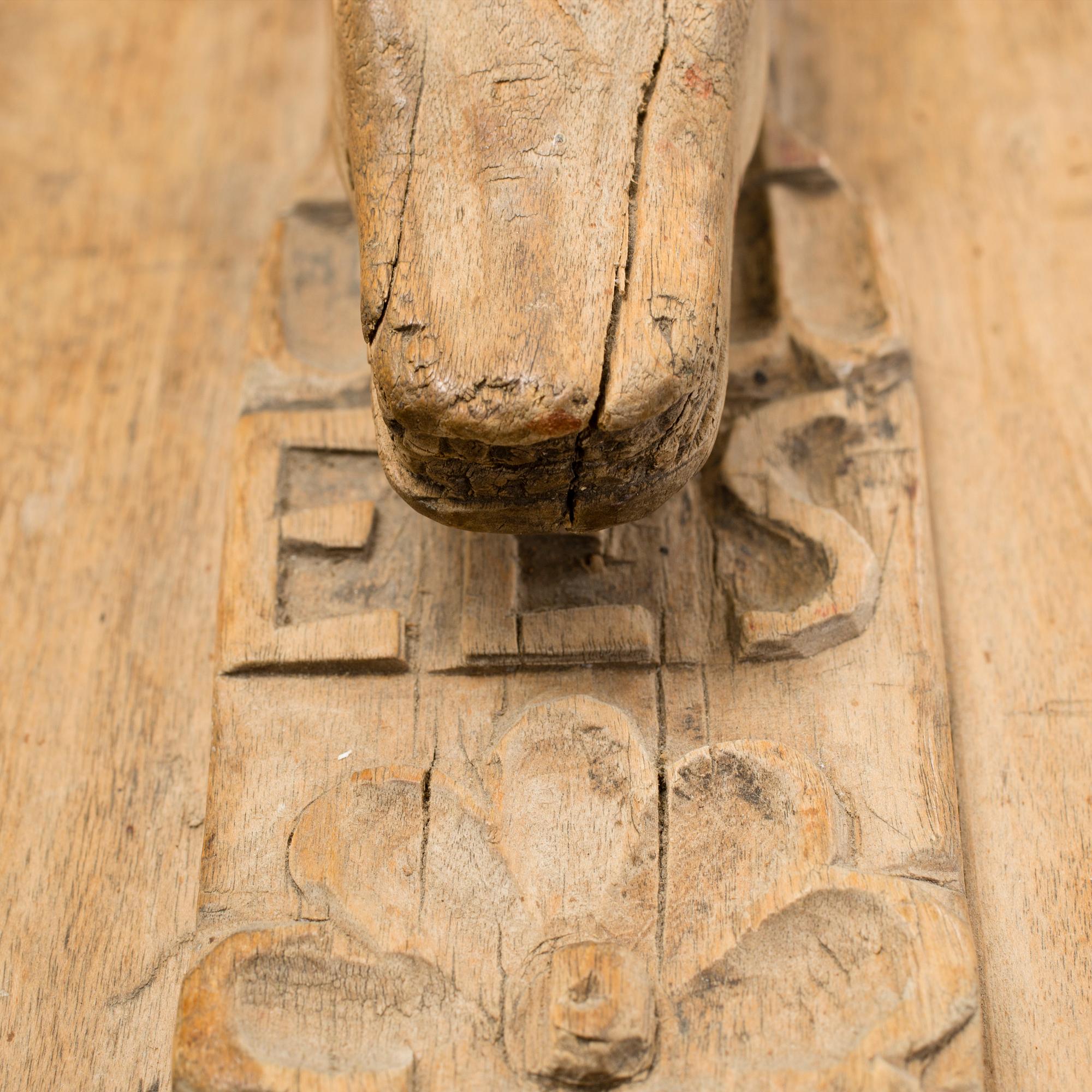 A Swedish folk art mangle board with carved decorationd, owners' initials and the date 1744.