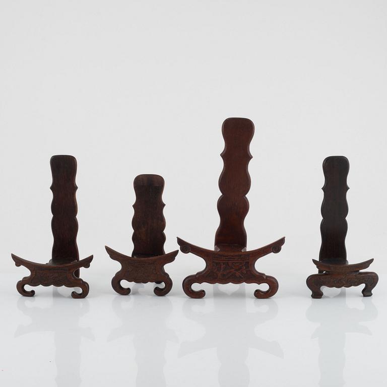 Seven hardwood stand for plates and vase, and one lid, China, 20th century.