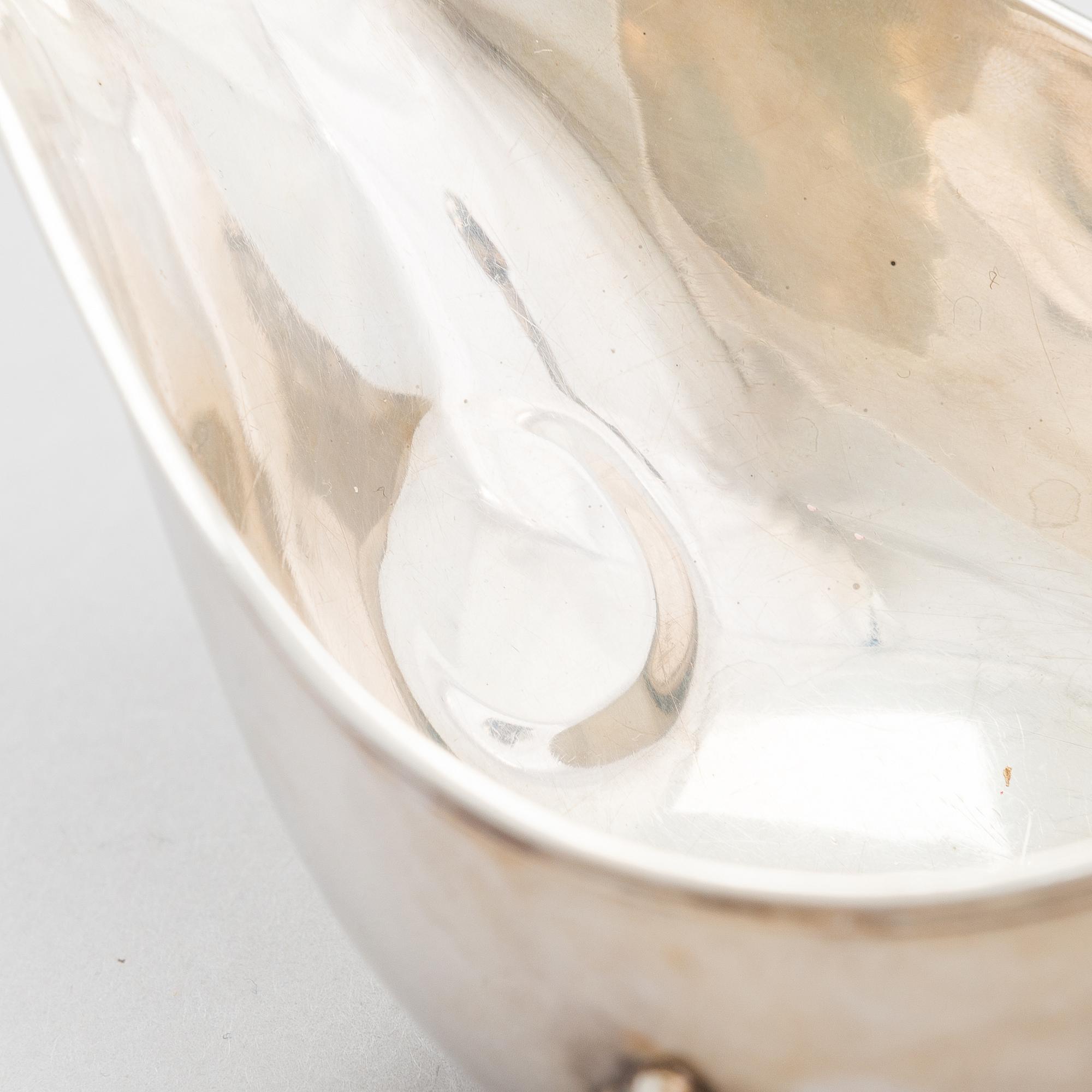 A pair of sauce jugs, maker's mark of Charles & George Asprey, London 1904, and 20th-century sauce jug. Sterling silver.