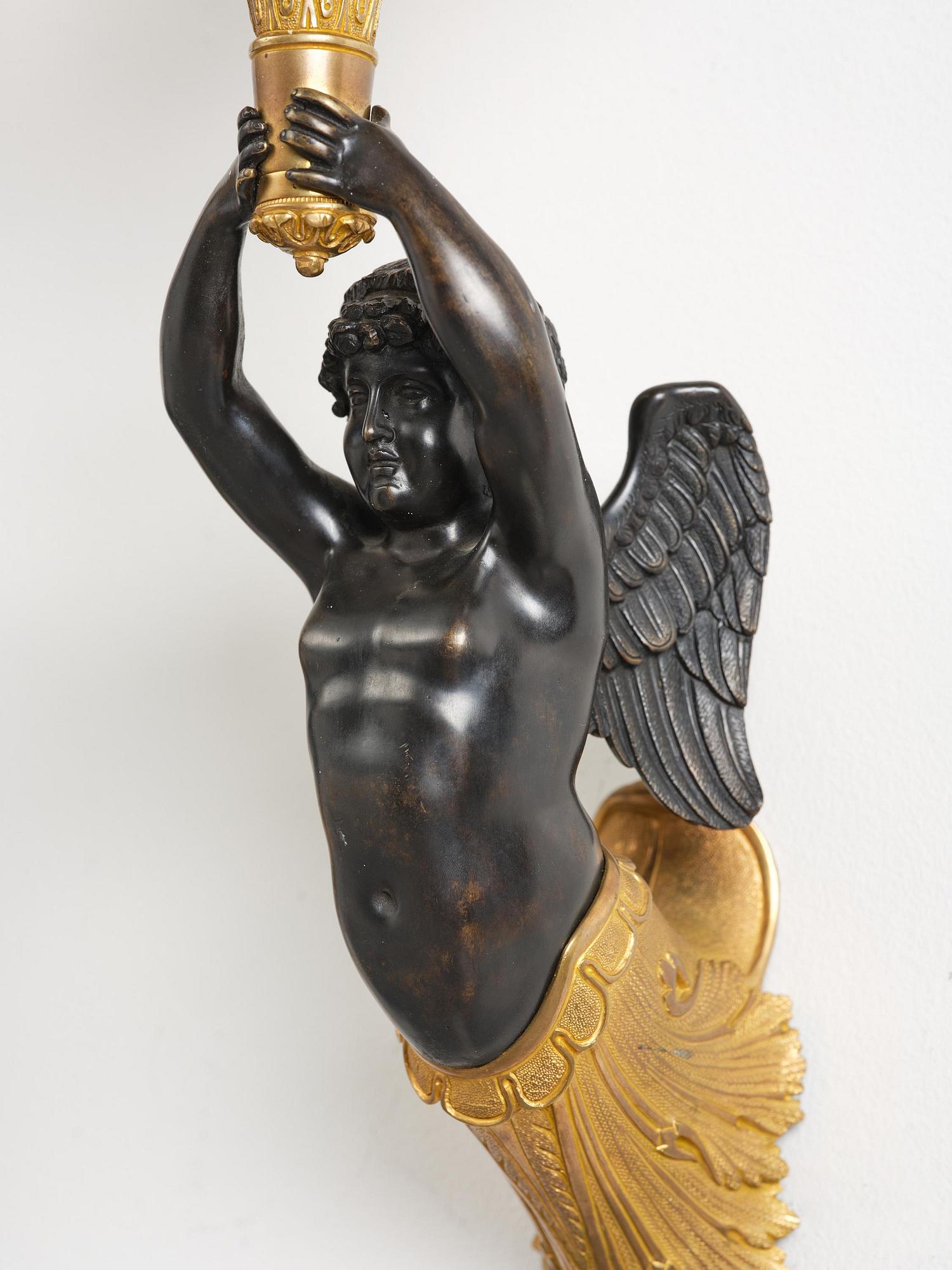 A pair of Napoleon III five-branch gilt and patinated bronze appliques.