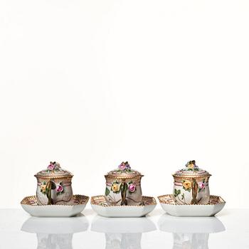 A set of 12 Royal Copenhagen 'Flora Danica' custard cups with covers and stands, Denmark, 20th Century.