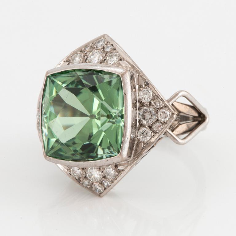 An 18K white gold ring set with a faceted tourmaline and round brilliant- and eight-cut diamonds.