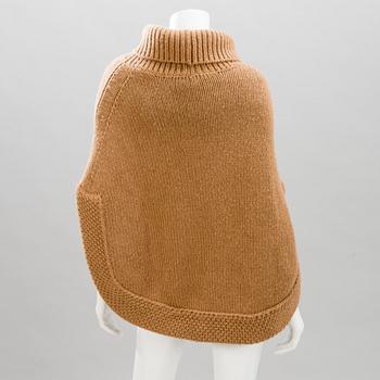 GUCCI, CAMEL HAIR PONCHO AND A HAT.