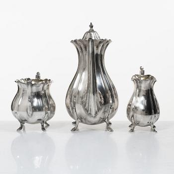 Guldsmedsaktiebolaget (GAB), A Swedish Rococo style silver coffee pot, cream jug and sugar bowl, mark of GAB, Stockholm 1918-1919.
