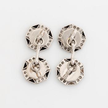 A pair of platinum and mother of pearl cufflinks set with round brilliant- and eight-cut diamonds and onyx.