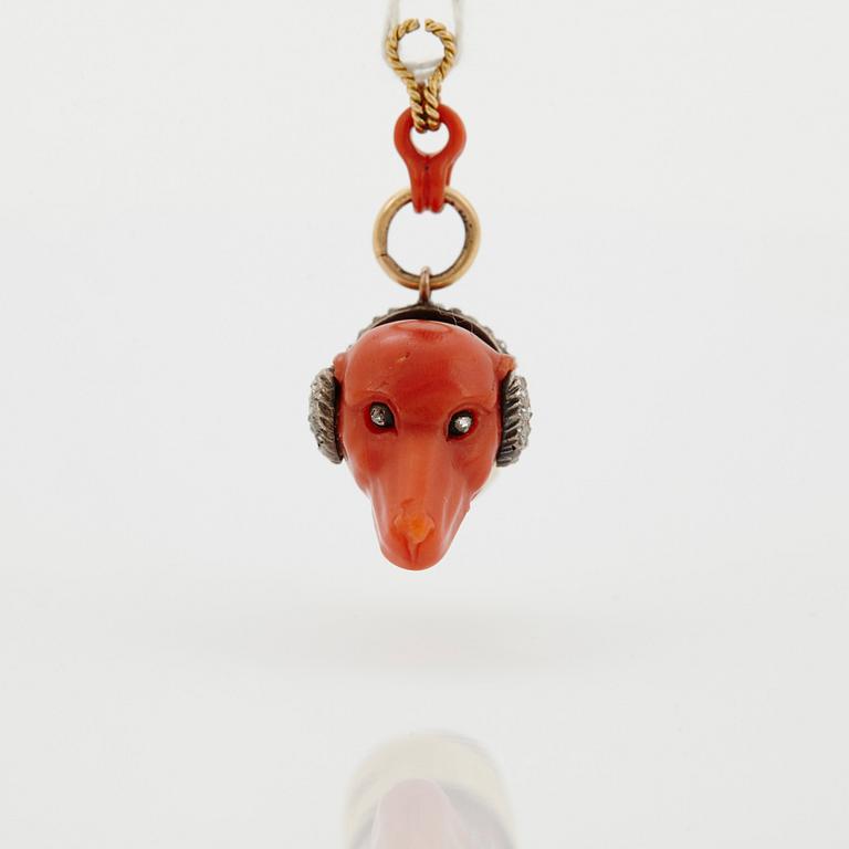 A 14 K gold and silver pendant with carved coral set with rose-cut diamonds.