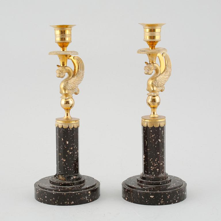 A pair of late Gustavian early 19th century porphyry and ormolu candlesticks.