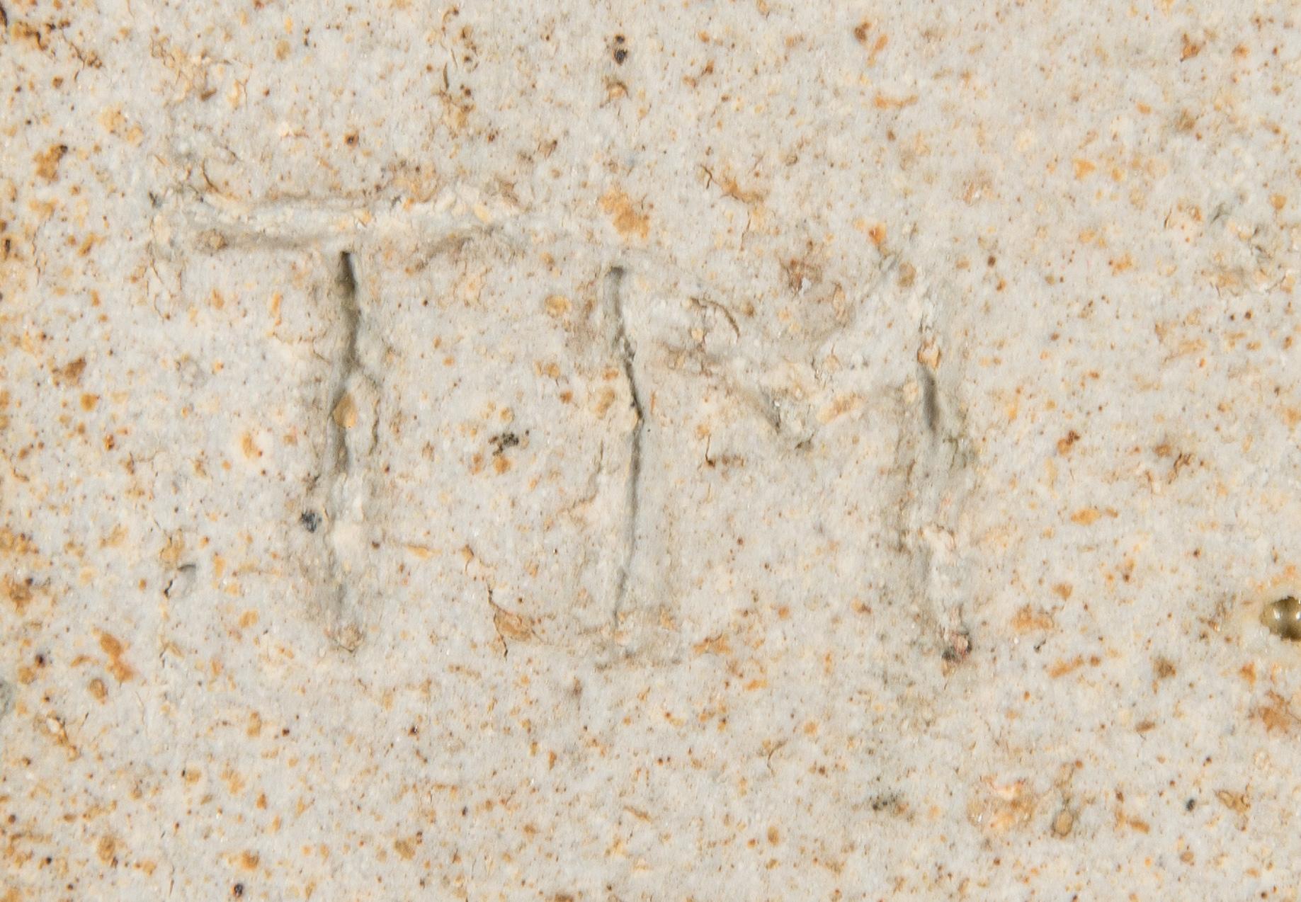 Toini Muona, a stoneware relief, signed TM.