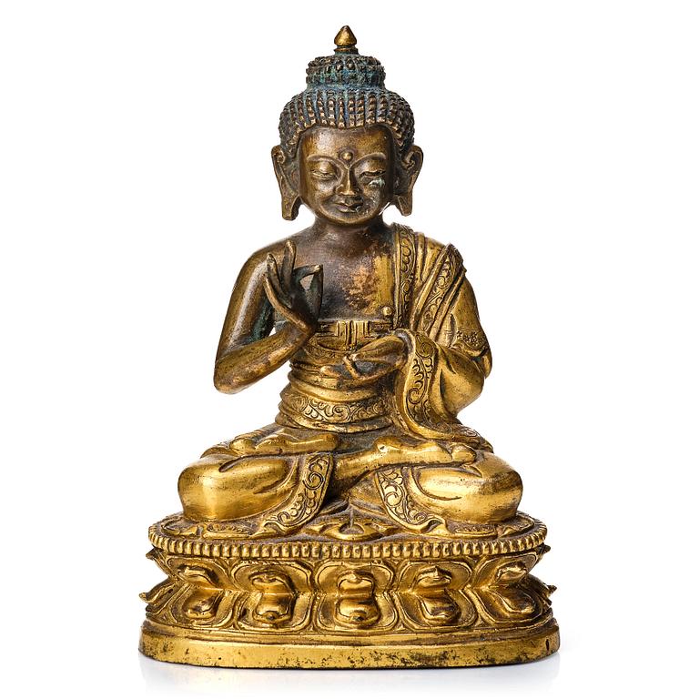 A partly gilt Tibeto-Chinese figure of Maitreya Buddha, 17th century.