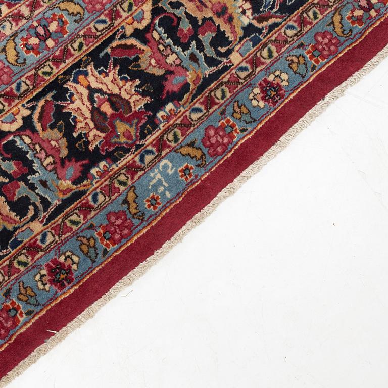 A carpet, Mashad, signed, ca 395 x 300 cm.