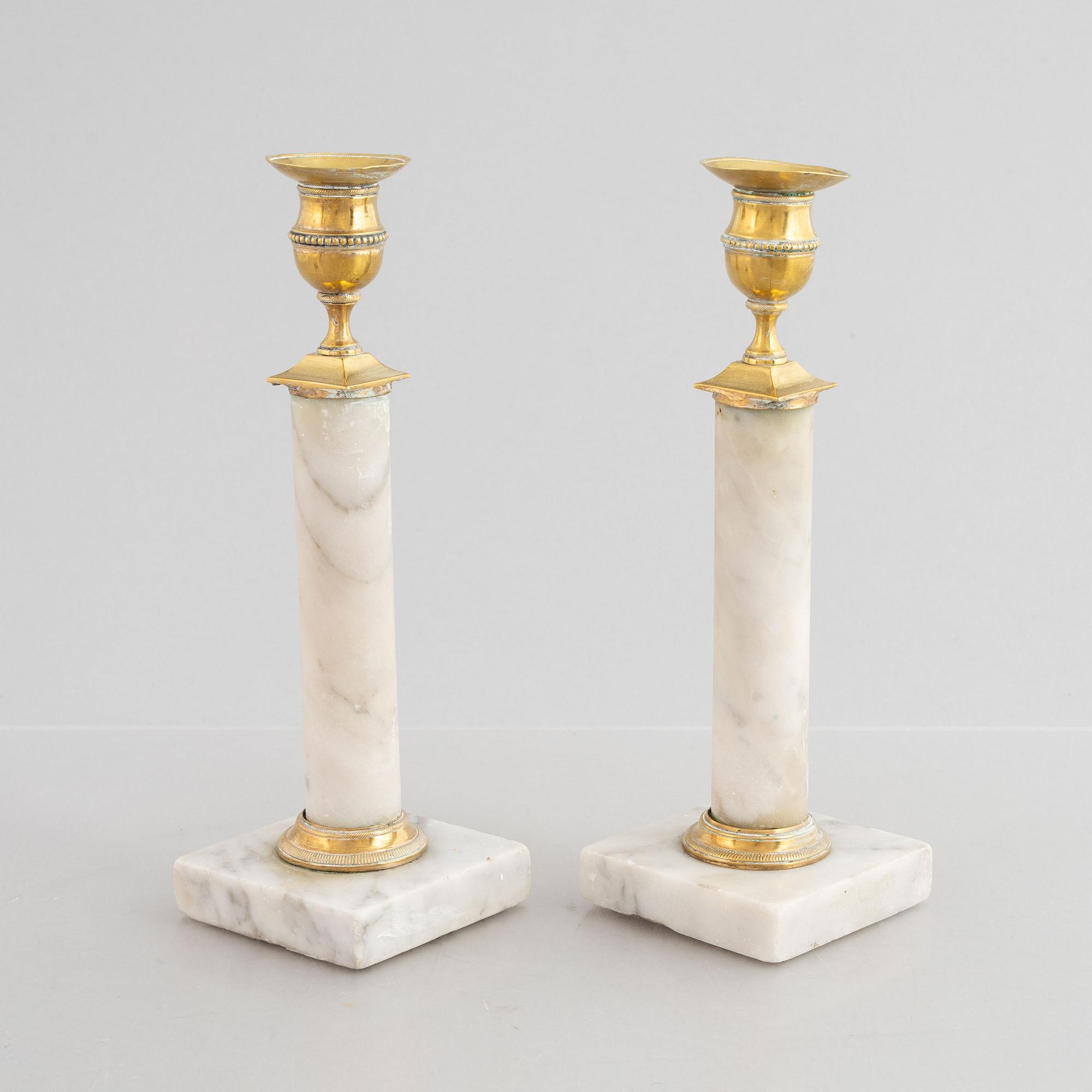 A pair of Gustavian gilt brass and marble candlesticks, late 18th century.