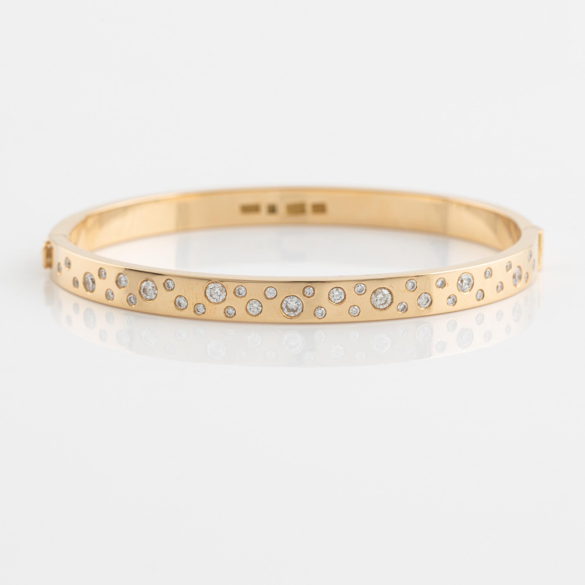 18K gold and brilliant cut diamond bangle.