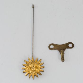 A Louis XVI-style mantle clock and a pair of candelabras. Early 20th century.