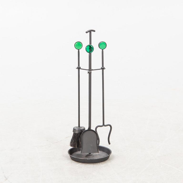 A set of three metal and glass fire place utensils and a candlestick by Gunnar Ander, second half of the 20th century.