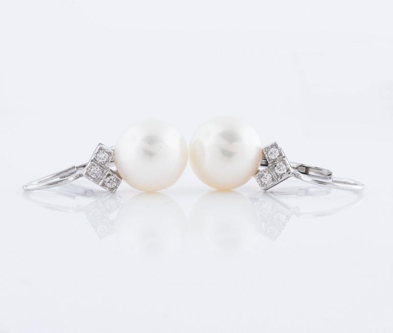 A pair of cultured pearl and ca 1.10 cts brilliant cut diamond earrings.