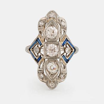 1090. An 18K white gold ring set with old-cut diamonds and faceted sapphires, probably synthetic.