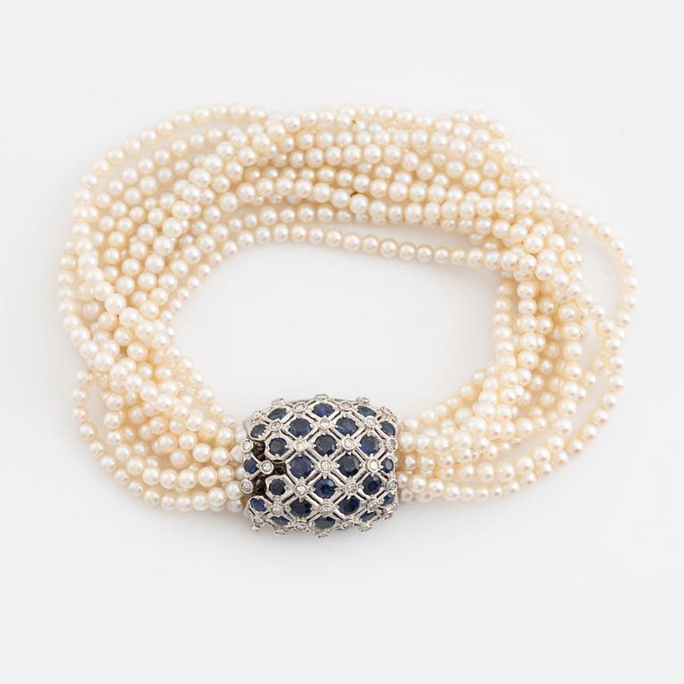 Cultured pearl bracelet, eleven strand, clasp white gold with sapphire and diamonds.