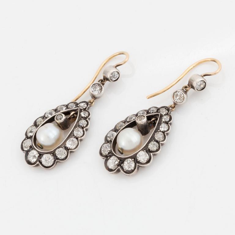 A pair of silver and gold earrings set with old-cut diamonds and pearls.