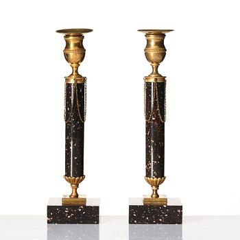 A pair of late Gustavian porphyry and gilt brass candlesticks, circa 1800.