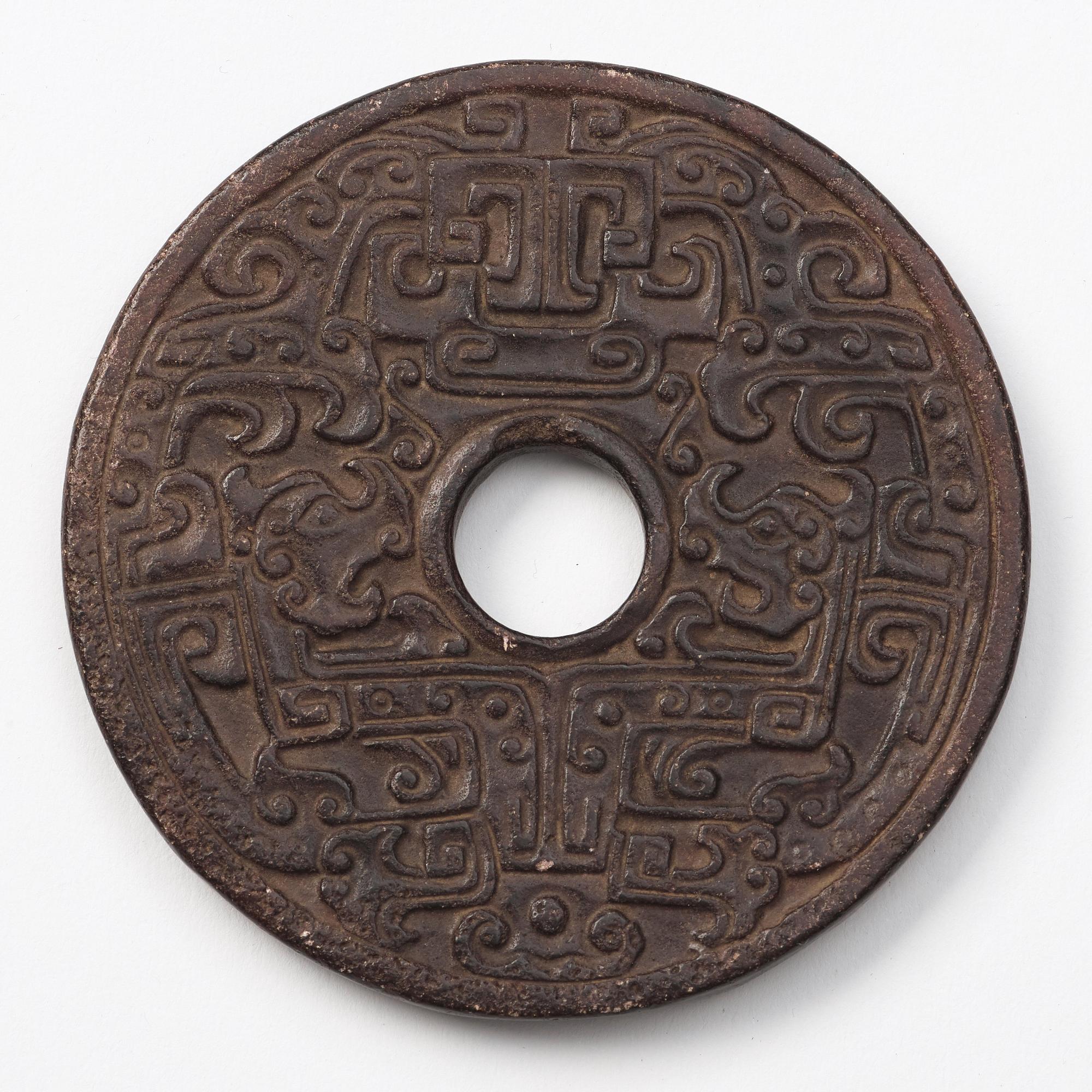A group of three archaistic Chinese stone bi discs and two pendants.